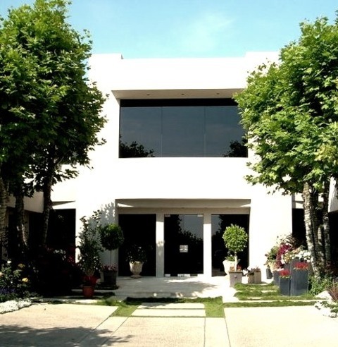 Roofing In Los Angeles Large Contemporary White Two-story Stucco Flat Roof Idea
