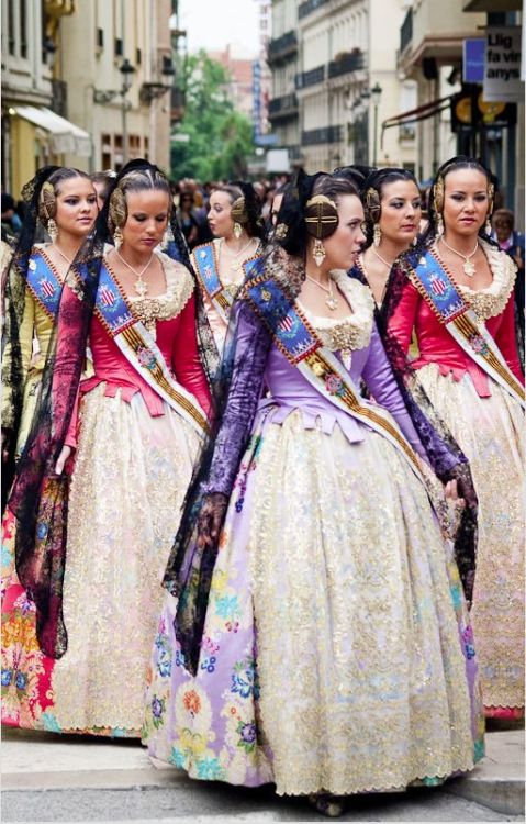 Women in the traditional dress of Valencia, Spain, called falla or fallera. It is based on the fashi
