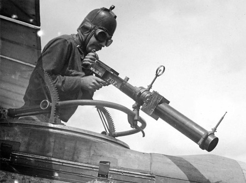 An American soldier poses with a Hythe Mk III Gun Camera duringtraining activities at Ellington Fiel