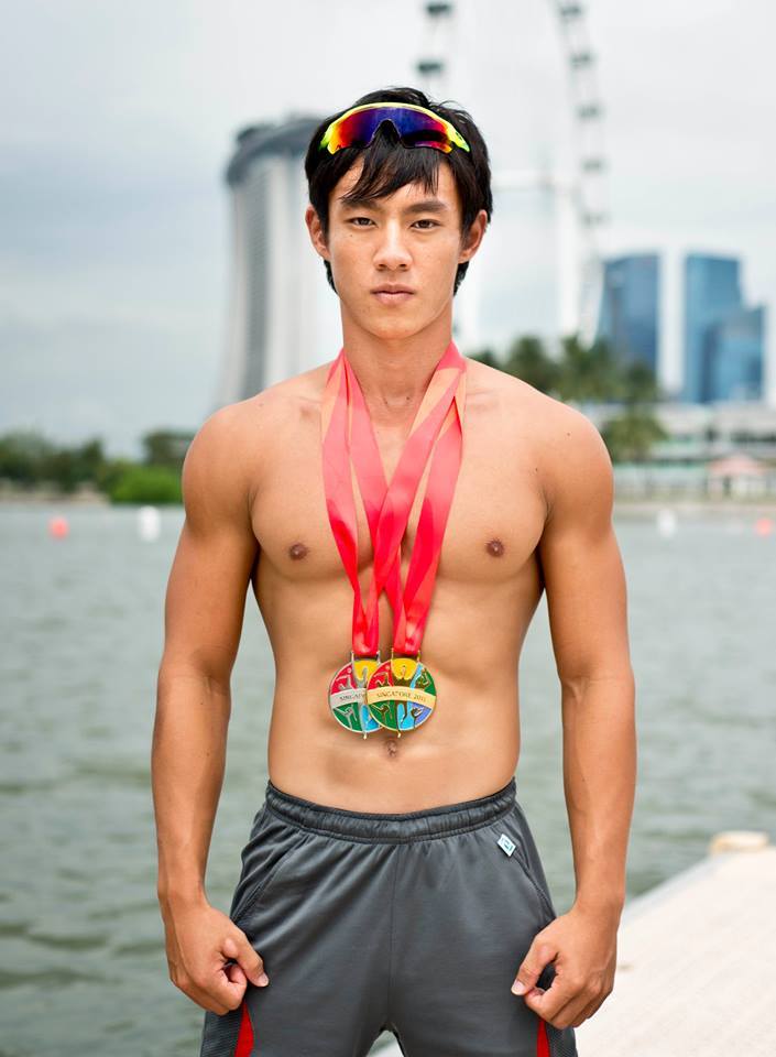 “TeamSG Canoeist Brandon Ooi Wei Cheng poses with his silver and gold medals“Source:
