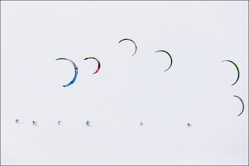 Snowkiting (or icekating) marathon during freezing blizzard on water reservoir near Tolyatti, Russia