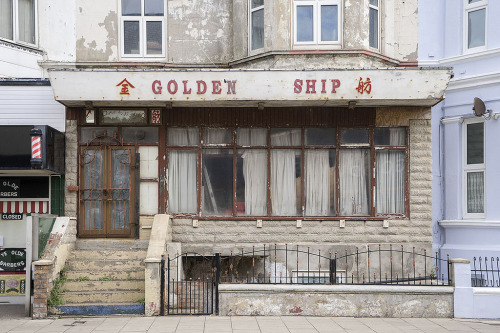 thessalian:  disease: A collection of bizarre shops throughout England, photographed by leon S-D. It amazes me that people think this is weird and to me it’s just “My commute home in an economy held together with spit and baling wire”. 