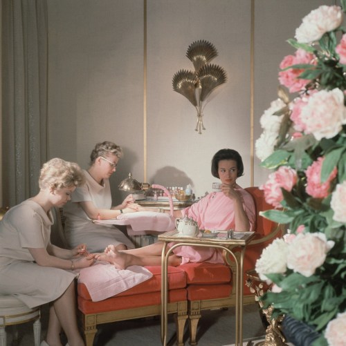 Gloria Vanderbilt receiving a manicure and pedicure at the house of Revlon and photographed by Horst