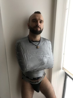 pigfun:1 2 3!  We didn’t do a before but I am wearing leather padded  fist mitts at the bottoms of this. First layer is black palette wrap and second is duck tape.  Third is a Regulation rubber bondage suit and then a breath through gag and more pallet