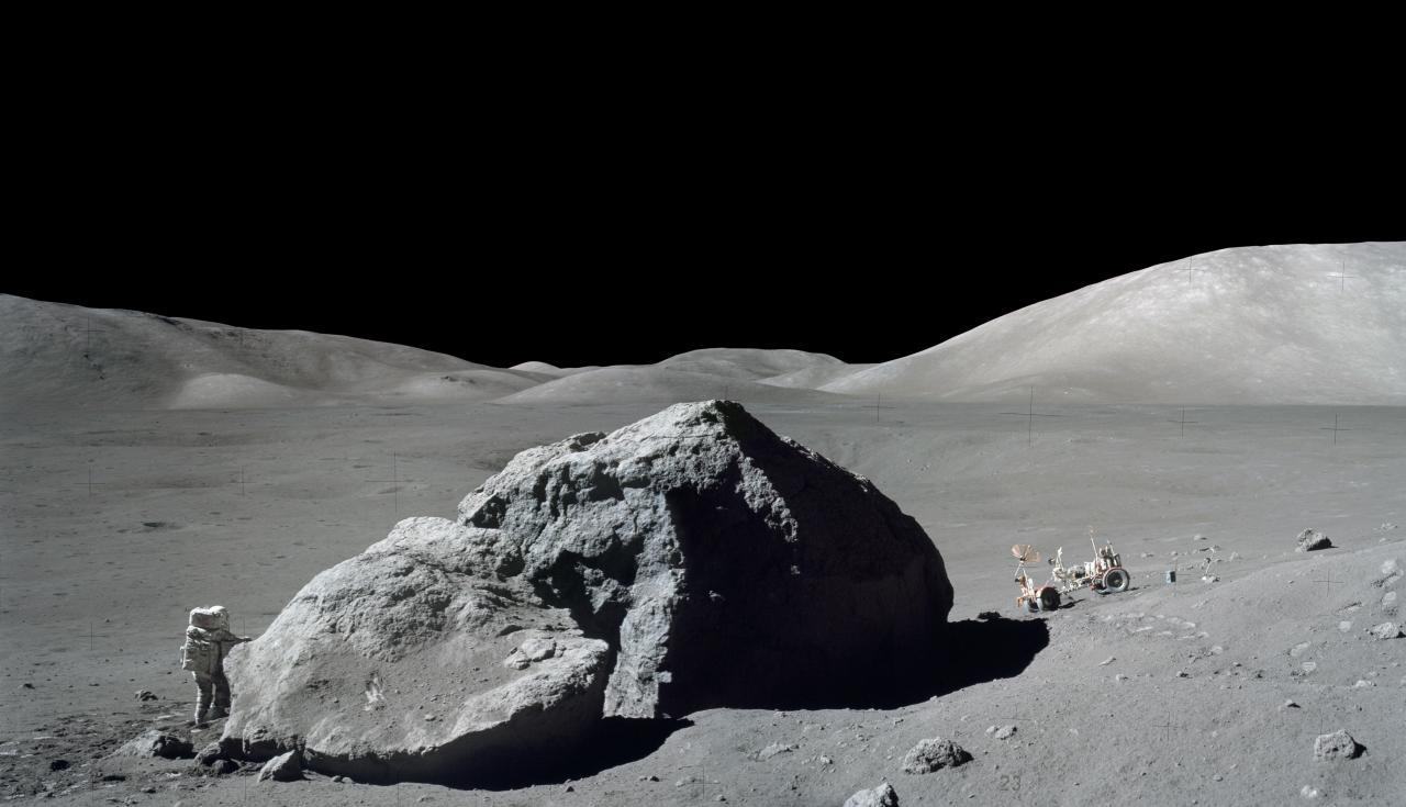 Harrison H. Schmitt of the Apollo 17 mission investigates a large lunar boulder with rover behind, on December 13th, 1972.
Photo courtesy of NASA.