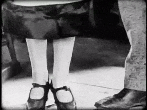 catskewl:The old, ‘oops… my hands are dirty/full, could you pull my garter back up?’ routine, in “Smouldering Fires”, 1925.