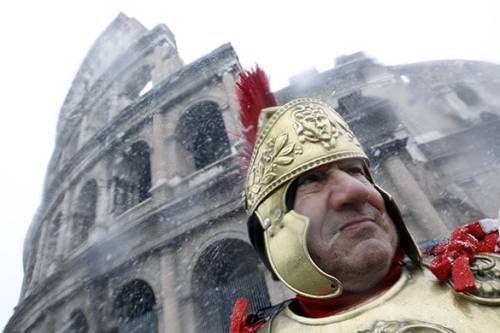 Fri 12 Feb 2010 : A man dressed as a Roman centurion watches the falling snow in front of Rome&rsquo