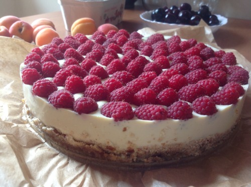 Cold vanilla tofu cake on raw almond-date crust with raspberries on top