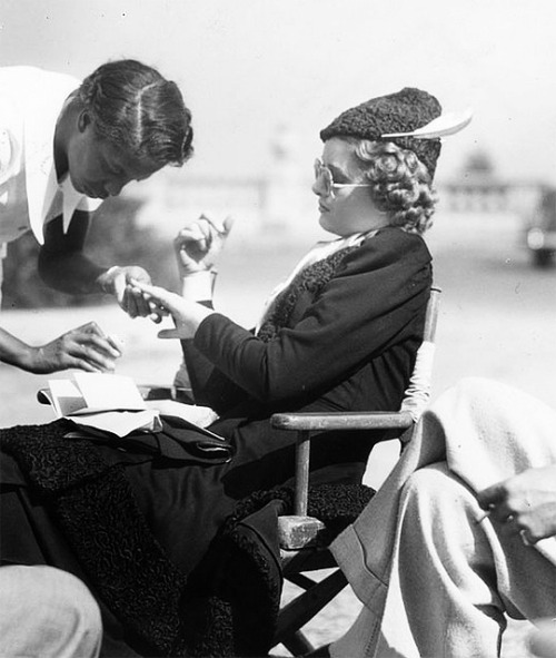 bettedavis:Myrna Loy getting her nails done on the set of After the Thin Man, 1936