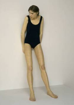 artmastered:  Ron Mueck, Ghost, 1998 The young girl represented in Ghost stands at around seven-feet tall. The awkwardness of her exceptional height, combined with her slumped shoulders, evokes the feeling of physical discomfort and unsureness. 