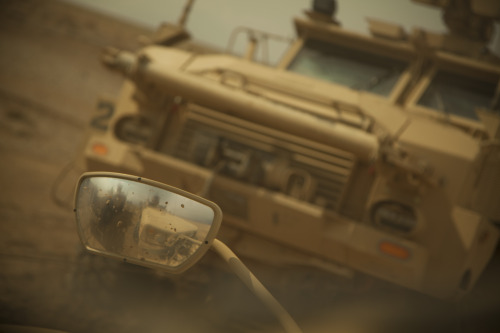 Winch me, baby. Coalition force members use winches to pull a stuck vehicle out of a soft spot in th