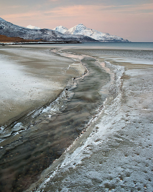 Freshwater stream on a frozen beach in Troms, Norway (by antonyspencer).