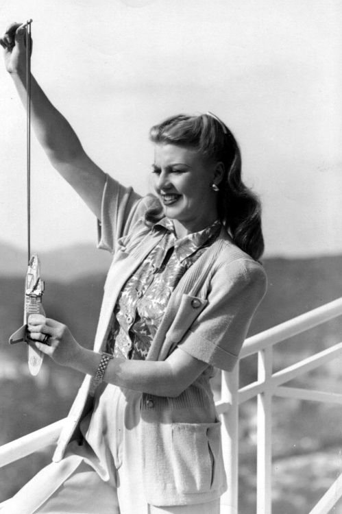 a-study-of-fred-and-ginger:Ginger Rogers in her natural, brunette state is very underrated. Here she is at home in the mid-1940s with a toy airplane. https://painted-face.com/