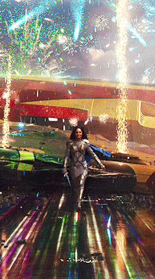 thorodinson:“Val emerges from the ship in full battle mode. Behind her, the Commodore FIREWORKS provide a spectacular HERO BACKDROP. She draws DRAGONFANG and smiles as Butchers begin swarming towards her. She is where she needs to be.” — Thor: Ragnarok