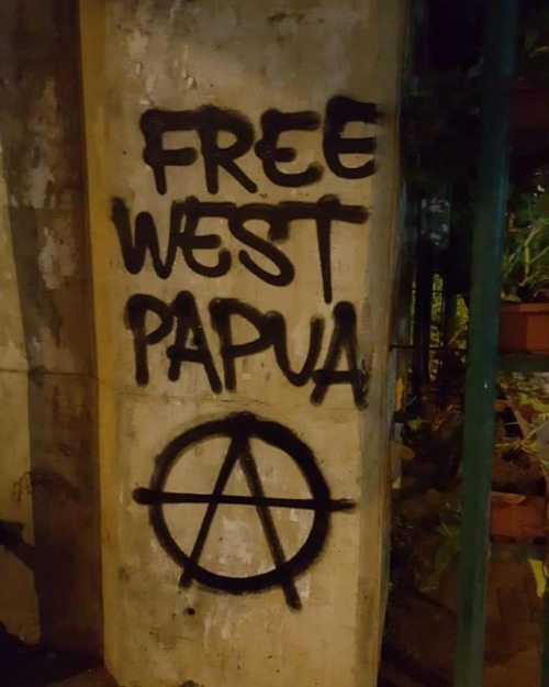 Anarchist graffiti and posters in solidarity with the West Papuan liberation struggle seen in Tanger