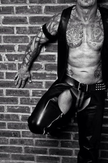 leatherman75011:  Just leaning against the wall, totally dressed in leather and tattooed,
