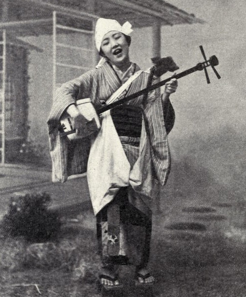 Playing the shamisen in 1899 Japan.  Image via Pinterest