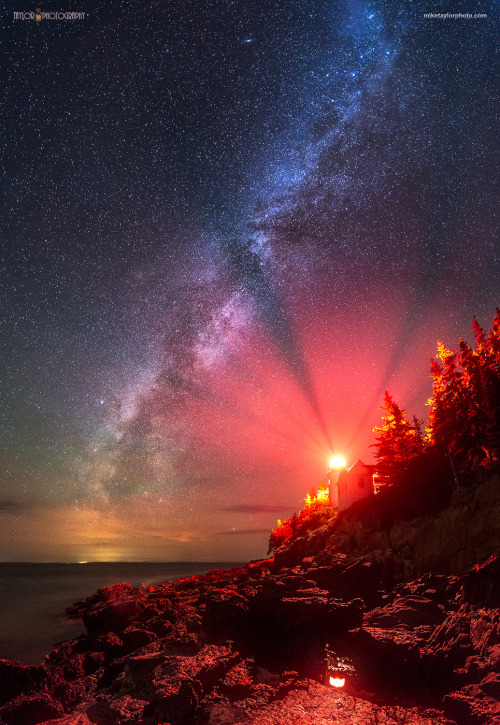 photos-worth:  Red Light District, by miketaylorphoto  The Milky Way stretches across the sky next to Bass Harbor Lighthouse in Acadia National Park. Photographing our night sky at any lighthouse is difficult. This spot is especially demanding due to