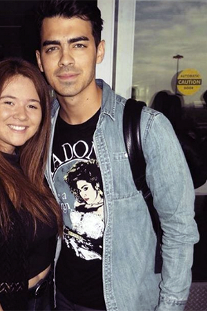 DECEMBER 22ND, 2015: Joe Jonas poses with a fan. Urban Outfitters Madonna Virgin Tour Tee &ndash