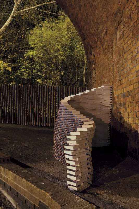 A strange structure grew and curved under a bridge in the Ouseburn, Newcastle one Monday night. What began as a temporary book shelter changed with each book laid, spine out to the street, camouflaging against the red of the brick. It rose up chest...