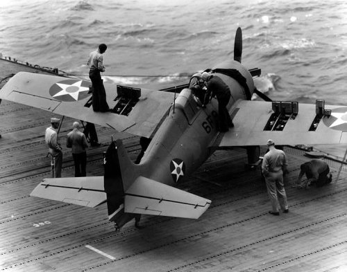 flying-fortress:  An F4F Wildcat having its guns loaded, USS Enterprise in early 1942.