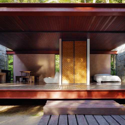 letsbuildahome-fr:  House in Rio Bonito by Carla Juaçaba Four steel beams puncture walls so as to allow a sliver of glazing to wash the interior of the stone walls with diffused light. The visual weight of the rustic stone counters the lightness of