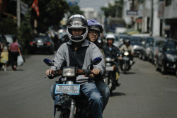 Man rides motorcycle. Bandung, Indonesia