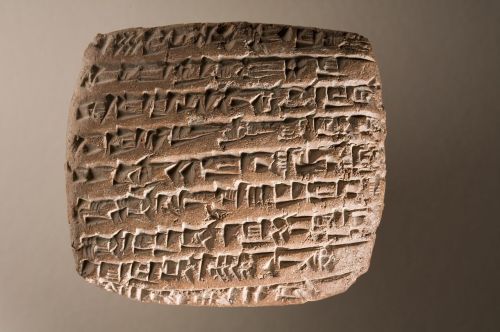 Ancient Mesopotamian cuneiform tablet and figurine discovered in a tomb dating to around 2,500 BC.Th