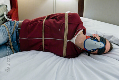 freavebond: Go ahead and struggle! Tight fist mitts, roped through his belt loops, I don’t think he was going to get loose. Sock gagged, mouth sealed shut with tight tape… some nice aromatherapy for the ride, too…