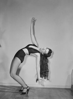 Hauntedbystorytelling: A Burlesque Performer Bending Over Backwards In A One-Piece