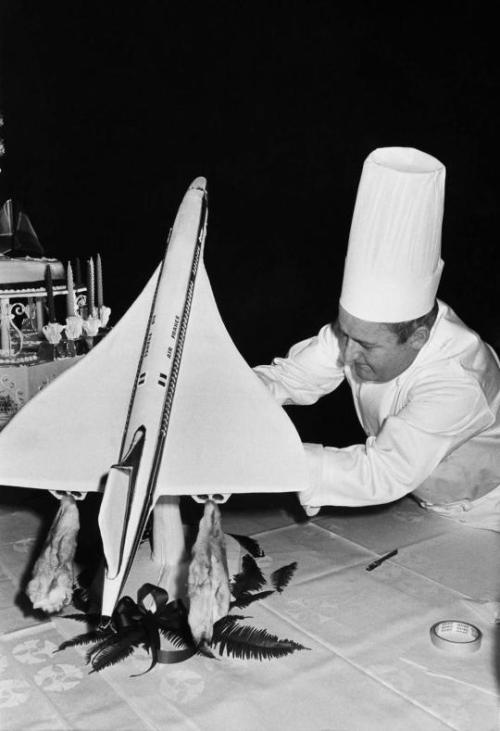 thevaultoftheatomicspaceage:A chef putting the final touches to a sugar model of the Concorde, 1965.