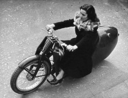  A woman test driving a motorcycle on the