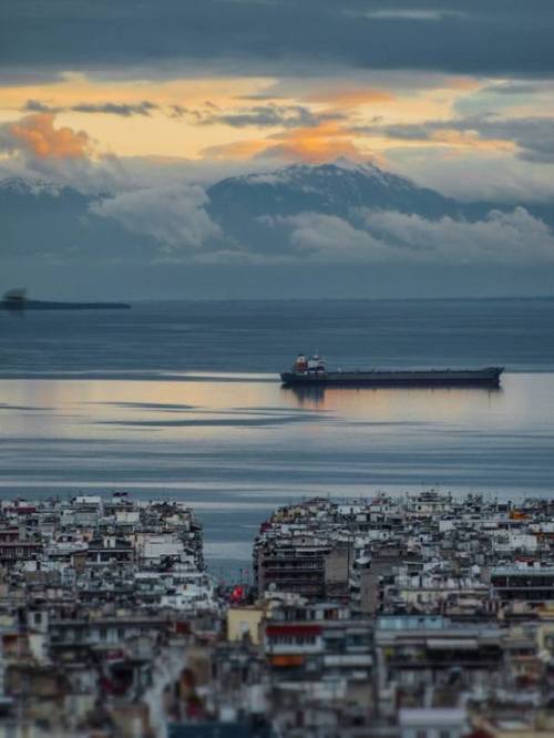 The urban view of Thessaloniki’s blocks of buildings and Mount Olympus in the background. 