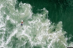 sixpenceee:  Bird’s eye view of a surfer in the famous beach of Praia Mole located in Florianopolis, Brazil. This image has been made with the help of a drone.“ Photograph and caption by Chris Schmid/National Geographic Traveler Photo Contest 