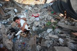 rudecatsgo:This boy has found his cat alive in the ruins of his home in Gaza. 