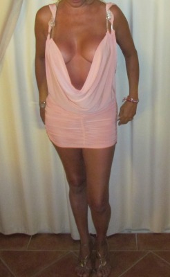 myhotshywife2:  Dressed as a slut for a swinging party. Tight pink dress highlights her hot body. Sorry for the poor quality resolution, guys. 