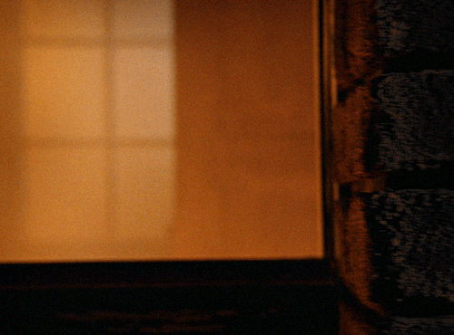 Athena in firefighter gear turning a corner in a burning building