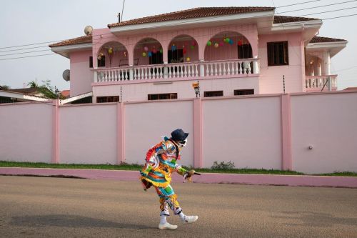 Masquerader wears a face mask during a street performance as the coronavirus disease (COVID-19) cont