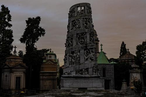 evilbuildingsblog:  Tower of bodies in a Cemetery in italy, sorrounded by epic tombs