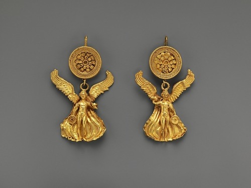 ancientjewels:Pair of Greek gold earrings depicting Eros. They date to around 300 BCE. From the Metr