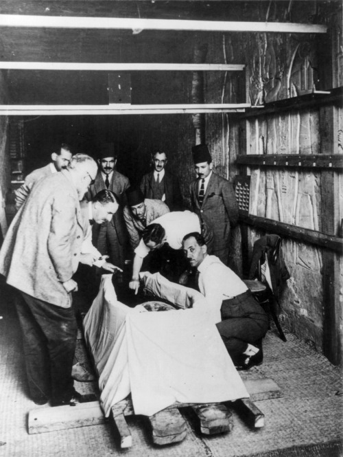 Howard Carter and his team look over the mummy of Tutankhamen after uncovering it in 1925. After fin