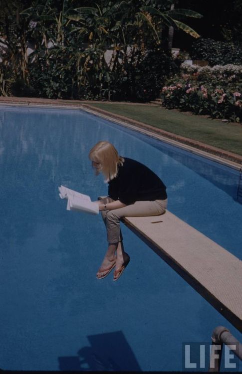 Actress May Britt reading over pool (1957). Photographer: Leonard McCombe. LIFE. Maybritt 
