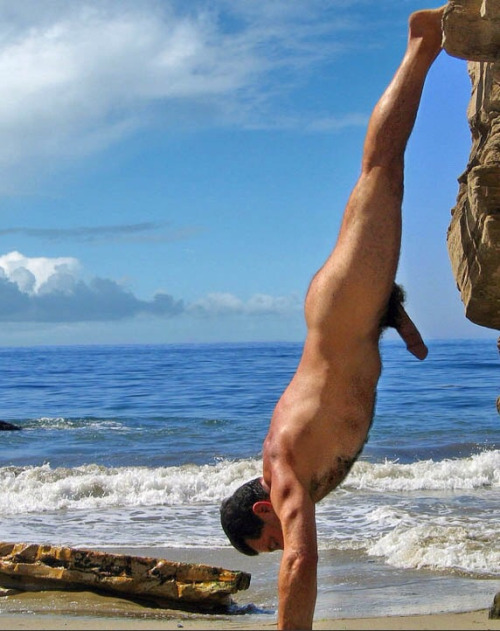 stratisxx: This hung daddy at the gay nude beach in mykonos shows his son how to really do a hand stand. Daddy’s super thick cock and hairy bush are unreal.  I hope his son is packing a similar whopper in his shorts. These two were hot…and I think