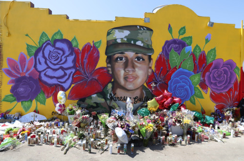 In Fort Worth, Texas, offerings sit in front of a mural of Army Spec. Vanessa Guillen. Guillen went 