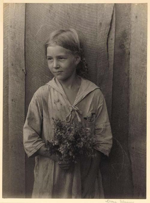 onceuponatown:Appalachian girl holding wildflowers. Unknown date.