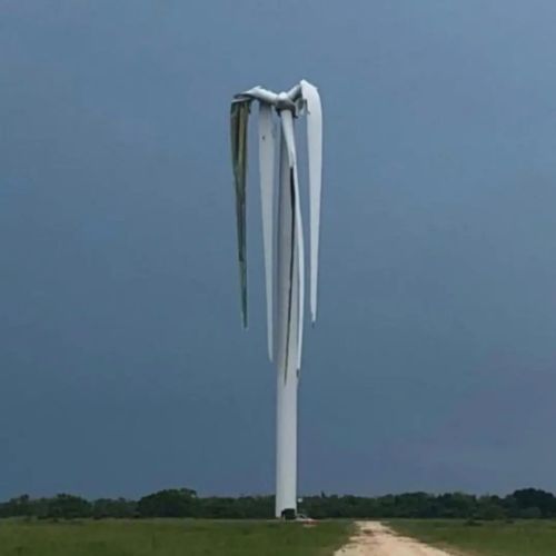 The wind turbine rotor blades look all sad before the sun comes out and they perk up like a flower. 