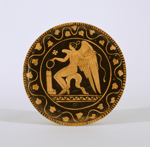 Eros makes an offering.  Apulian red-figure plate, attributed to the Ascoli Satriano Painter; ca. 34