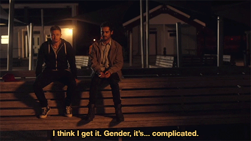 Caz, a lighter skinned Maori trans man, sits on a bench beside Jem, a cis man that he dated prior to transitioning. It is nighttime, and they are alone together. Caz is the protagonist of Rurangi. Jem says "I think I get it. Gender, it's... complicated."