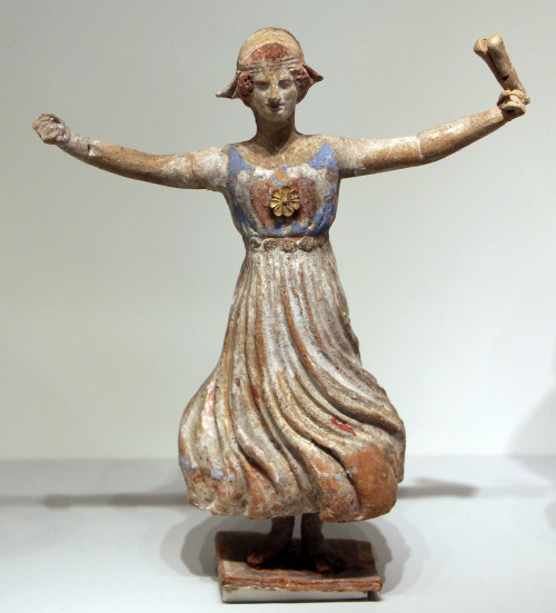 Ancient Greek painted terracotta statuette, depicting a dancer who holds a castanets-like percussion