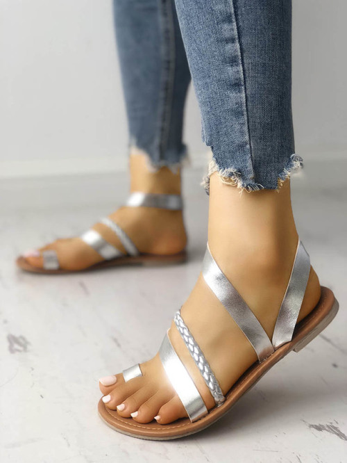 Beautiful silver toe ring sandals on pretty feet.